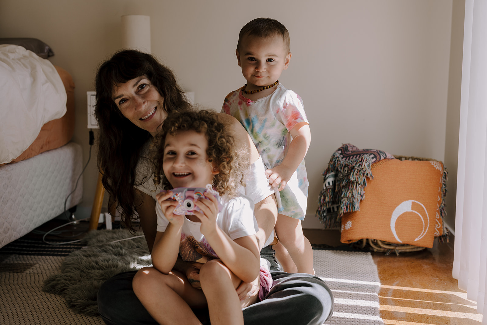 Chrissy Beth and her two children sharing a relaxed moment at home.